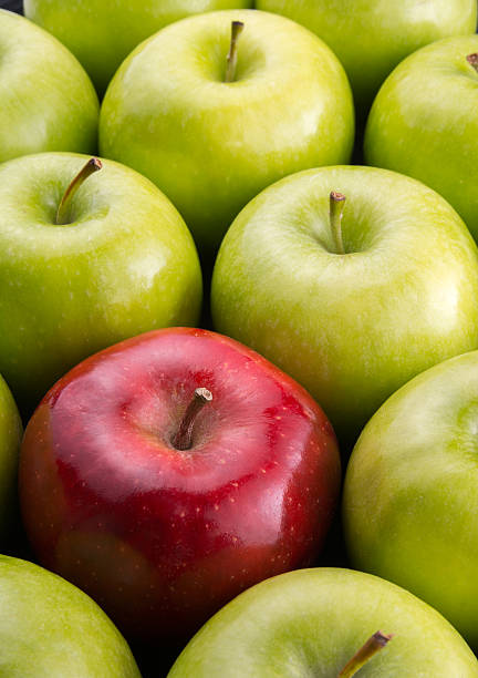 istock Unique. Red apple among group of green apples. 599280606