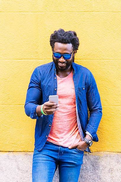 istock African Young Man Using Mobile In The Street. 599282762
