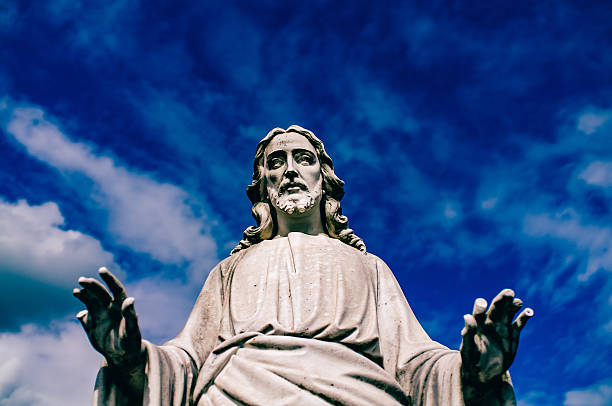 istock Low Angle View Of Jesus Statue Against Blue Sky 599411957