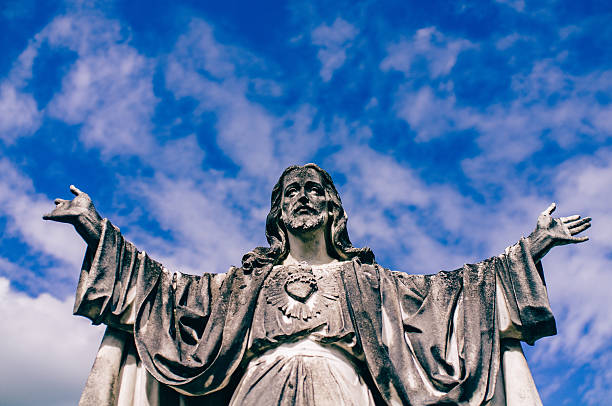 istock Low Angle View Of Jesus Statue Against Blue Sky 599411959