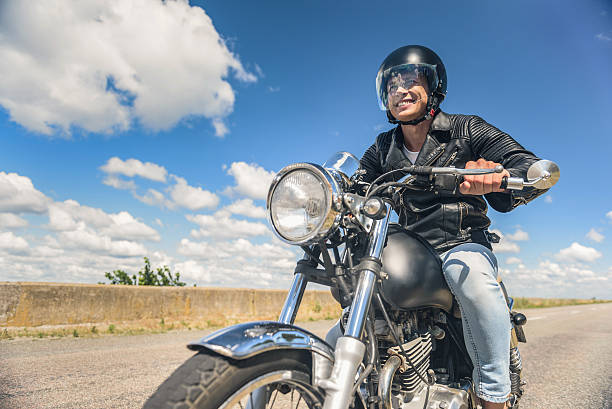 istock Young man riding his motorbike on open road 599459430