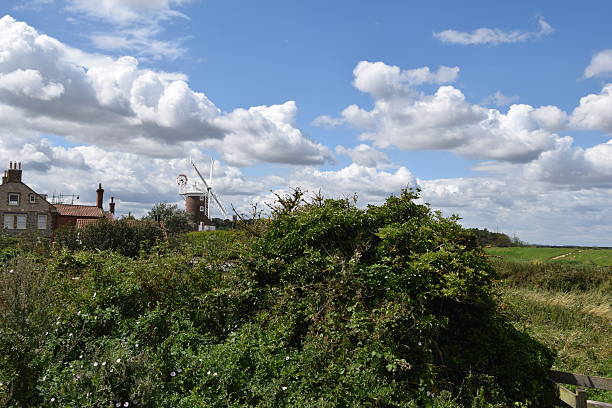 istock Windmill in beautiful countryside blue skies 599460124