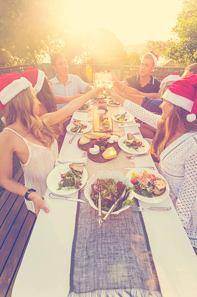 istock Group of people toasting with Santa hats. 599461152