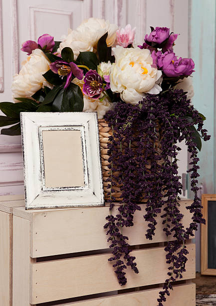 istock Picture frame and flowers on wooden box 599462270