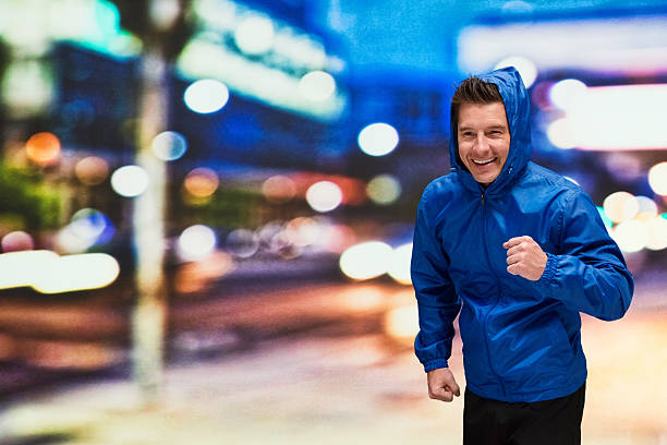 istock Smiling male running outdoors at night 599463298
