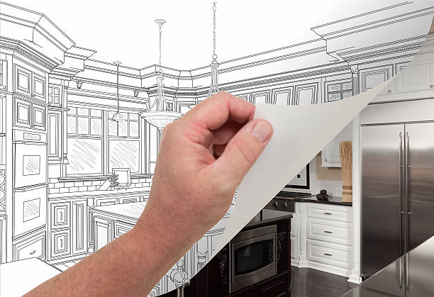 istock Hand Turning Page of Custom Kitchen Drawing to Photograph. 599463388
