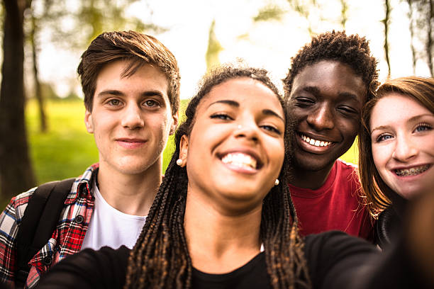 istock Group of college student laughing and doing a selfie 599465070