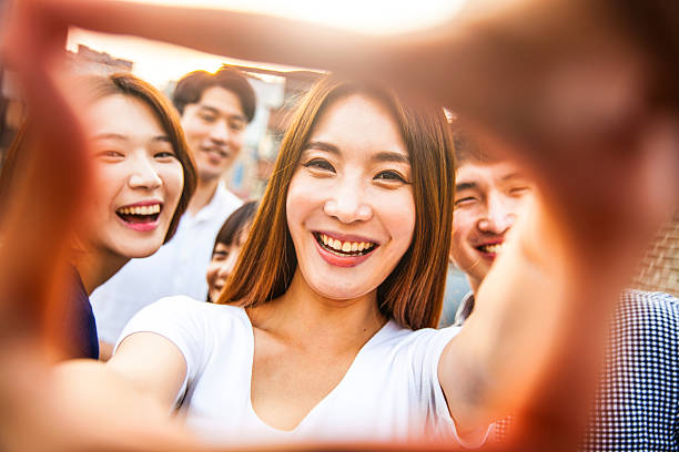 istock People having fun, taking a Selfie all together at party 599465794