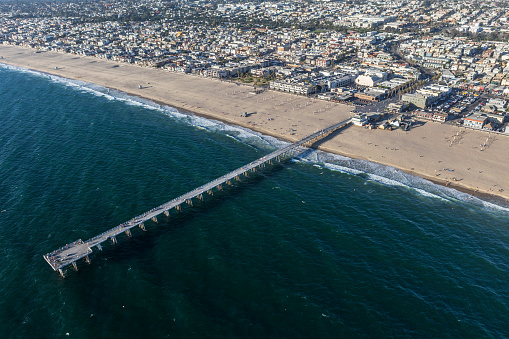 Afternoon aerial view of Hermosa Beach pier, sand and sea near Los Angeles in southern California.