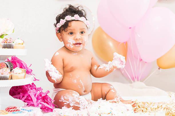 istock Baby Girl With Cake and Balloons 599467424