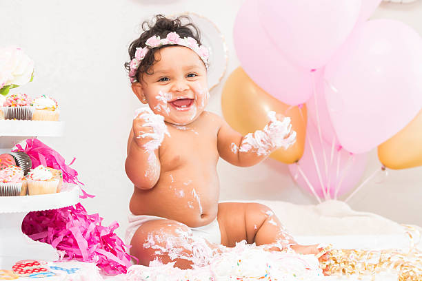 istock Baby Girl With Cake and Balloons 599467486