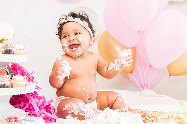 istock Baby Girl With Cake and Balloons 599467776