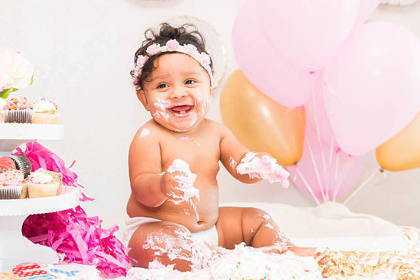 istock Baby Girl With Cake and Balloons 599467876