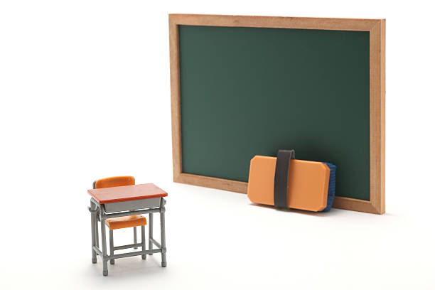 istock Miniature chalkboard and school desk on white background. 599468500