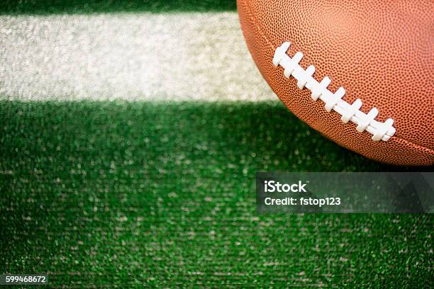 American Football On Green Turf At Yard Line Marker Stock Photo - Download Image Now