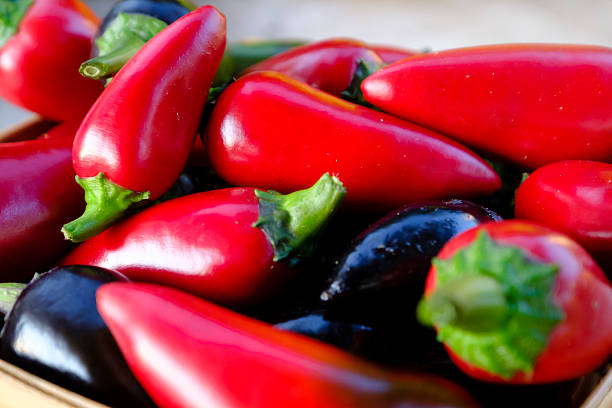 istock Red and black jalapeo peppers in basket. 599470640