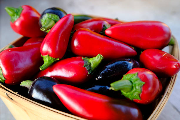 istock Red and black jalapeo peppers in basket. 599470664