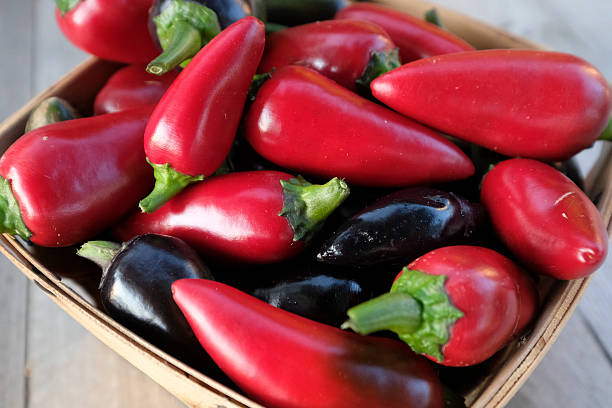 istock Red and black jalapeo peppers in basket. 599470696