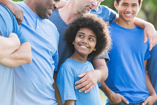 istock Mixed race African American boy with group of men 599471108