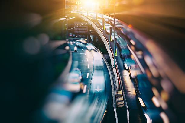 blurred traffic in central district The urban view of vehicle light trails on the road. bustling city stock pictures, royalty-free photos & images