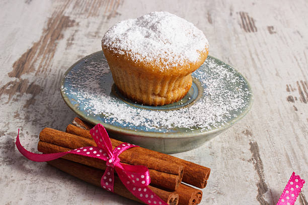 istock Fresh muffins with powdered sugar and cinnamon sticks, delicious dessert 599479302