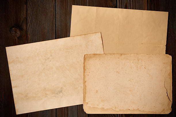 istock Vintage paper on textured old wooden background 599480146