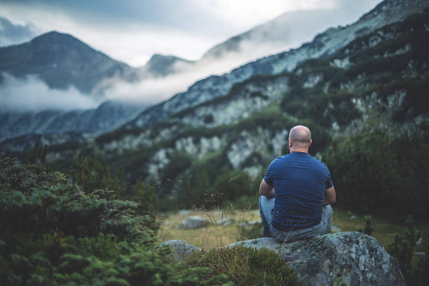 istock Traveler sits on a rock and enjoying the view 599481426