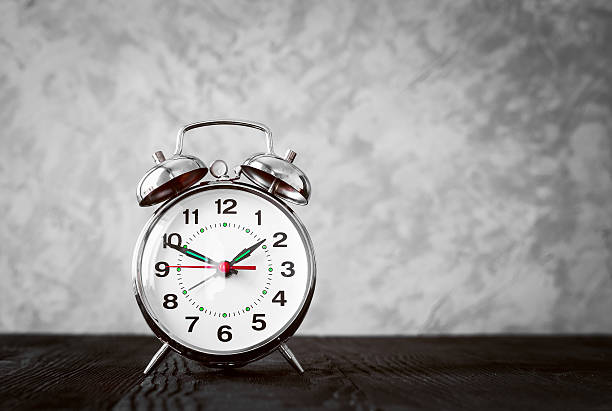 istock alarm clock at empty locker on white background close up 599481446