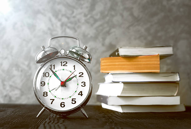 istock alarm clock time to read books 599481524