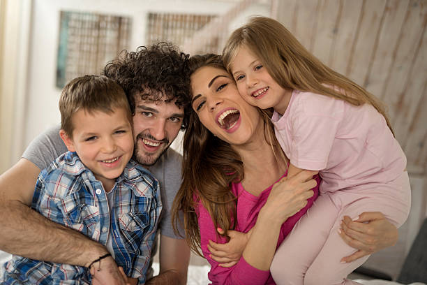 istock Cheerful parents with children laughing and looking at camera. 599485594