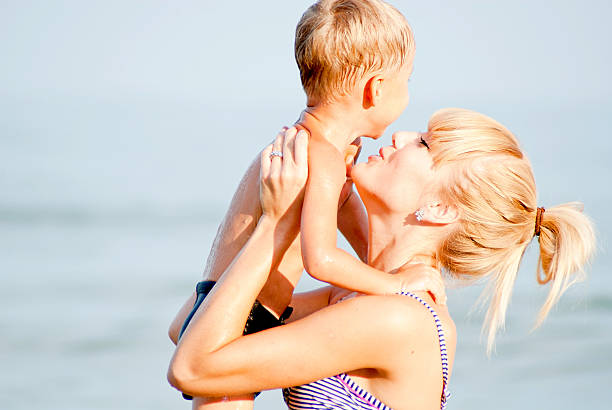 istock happy child with young mom on the sea 599488120