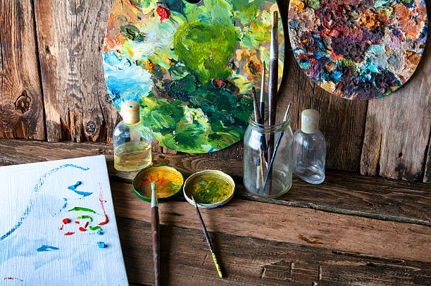 istock Palettes, brushes and canvas in an old painting workshop 599488510