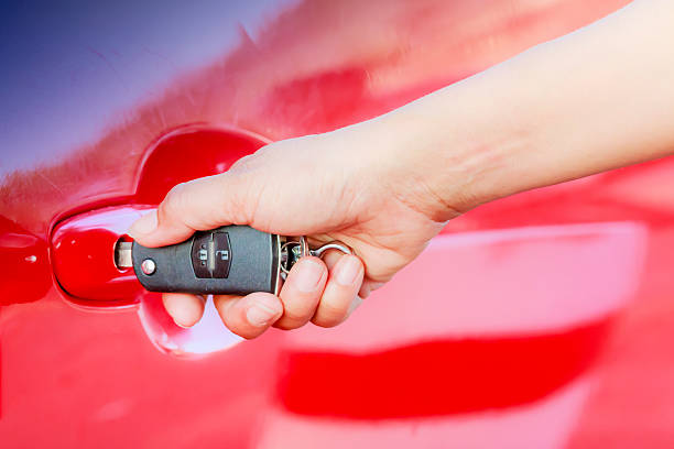 istock Hand Opens a Car Door with a Key on vintage 599488630