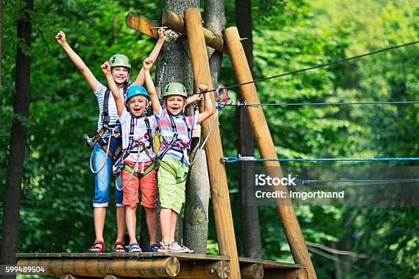 Kids Having Fun In Ropes Course Adventure Park Stock Photo - Download Image Now - Summer Camp, Child, Zip Line