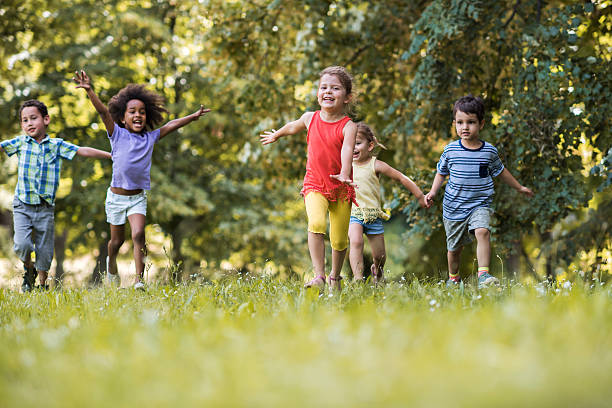 istock Happy children having fun while running in the park. 599489550