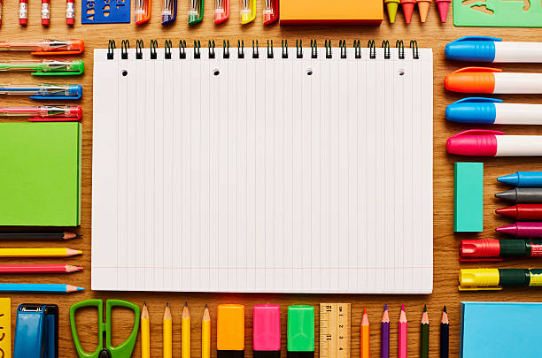 istock Spiral notebook surrounded by school supplies on table 599492674