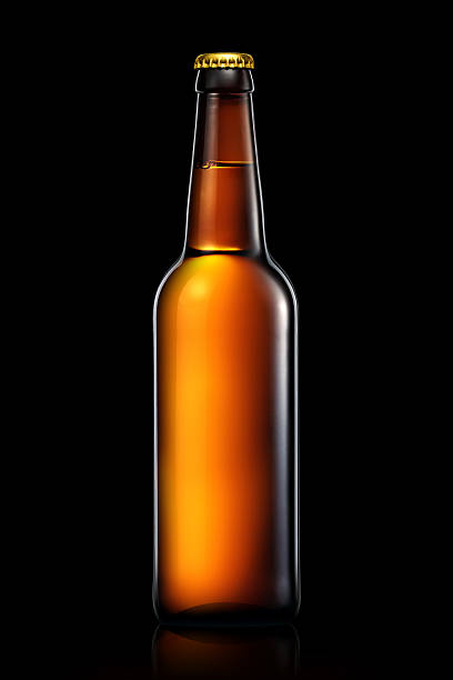 istock Bottle of beer or cider isolated on black background 599493788