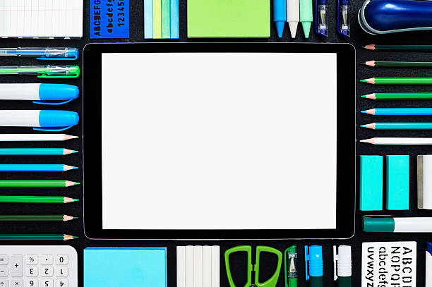 istock Blank digital tablet surrounded by school supplies on blackboard 599494706
