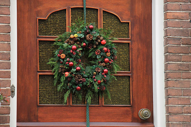Classic christmas wreath with decorations on a wooden door