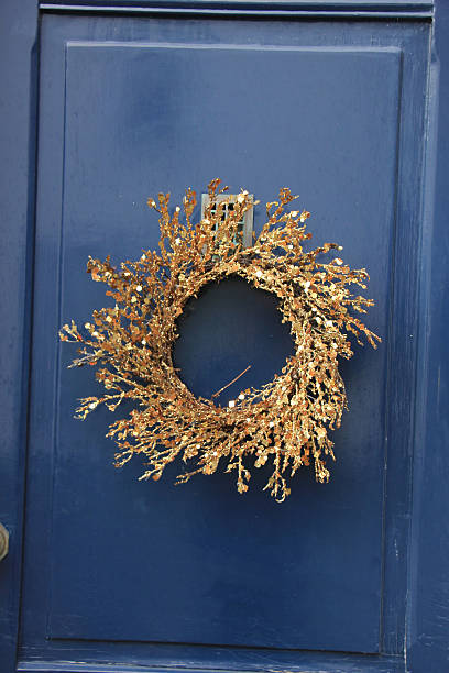 istock Golden wreath on a blue door 599496818