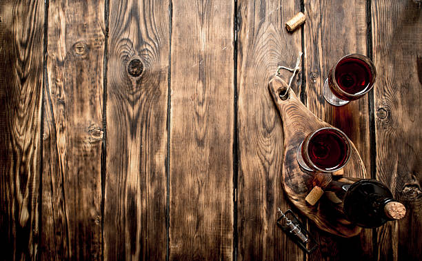 istock Red wine on wooden Board with stoppers and a corkscrew. 599497126