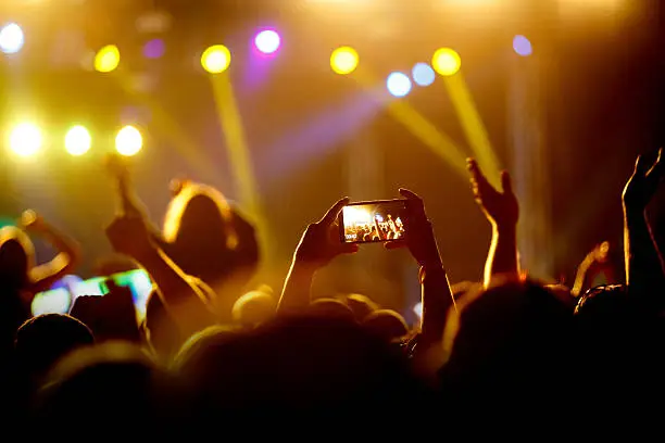 Photo of The smartphone in the hands of a concert