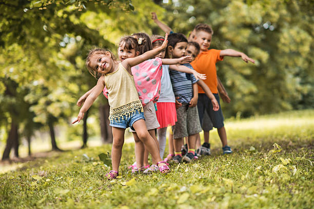 istock Group of happy kids having fun in the park. 599498346