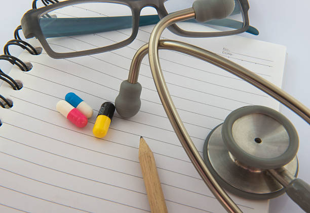 istock Colorful  capsule drug on white  book background 599502000