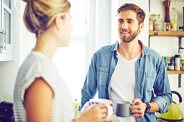 istock Smiling man looking at woman while holding coffee cup 599503888