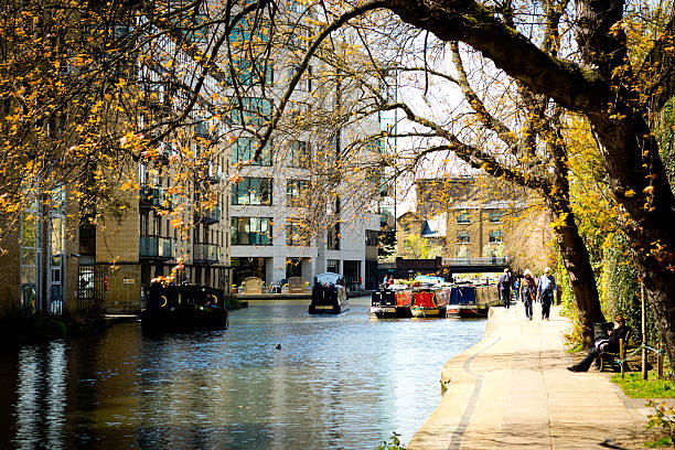 Narrowboating Kings Cross. London, Uk - May 1, 2016: Narrowboating at Kings Cross near Camden Lock. There  is a narrowboat on the Regents canal in this up and coming development area of London. regents canal stock pictures, royalty-free photos & images