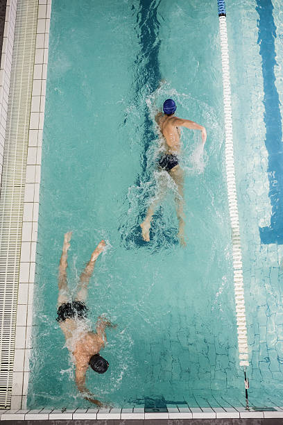 istock Swimmers doing the freestyle stroke in swimming pool 599673738