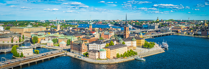 Panoramic aerial view over the blue summer skies above the iconic waterfront of Gamla Stan and Sodermalm in the heart of Stockholm, Sweden's vibrant capital city.