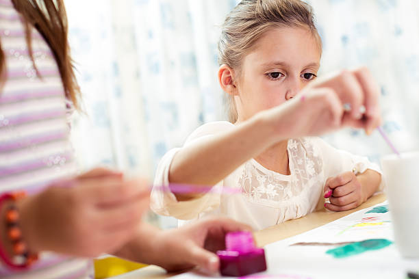 istock Child painting at easel 599674818