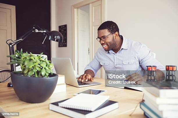 Afro American Young Man In A Home Office Stock Photo - Download Image Now - Working At Home, Men, Happiness
